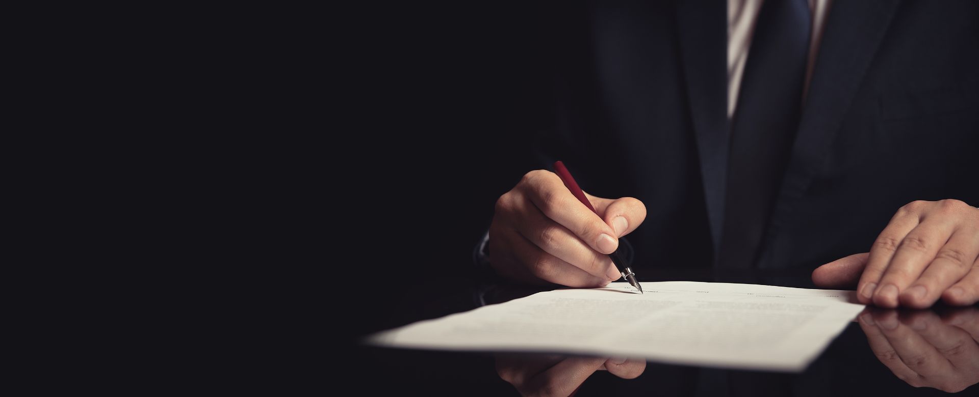 lawyer writing on paper with an ink pen